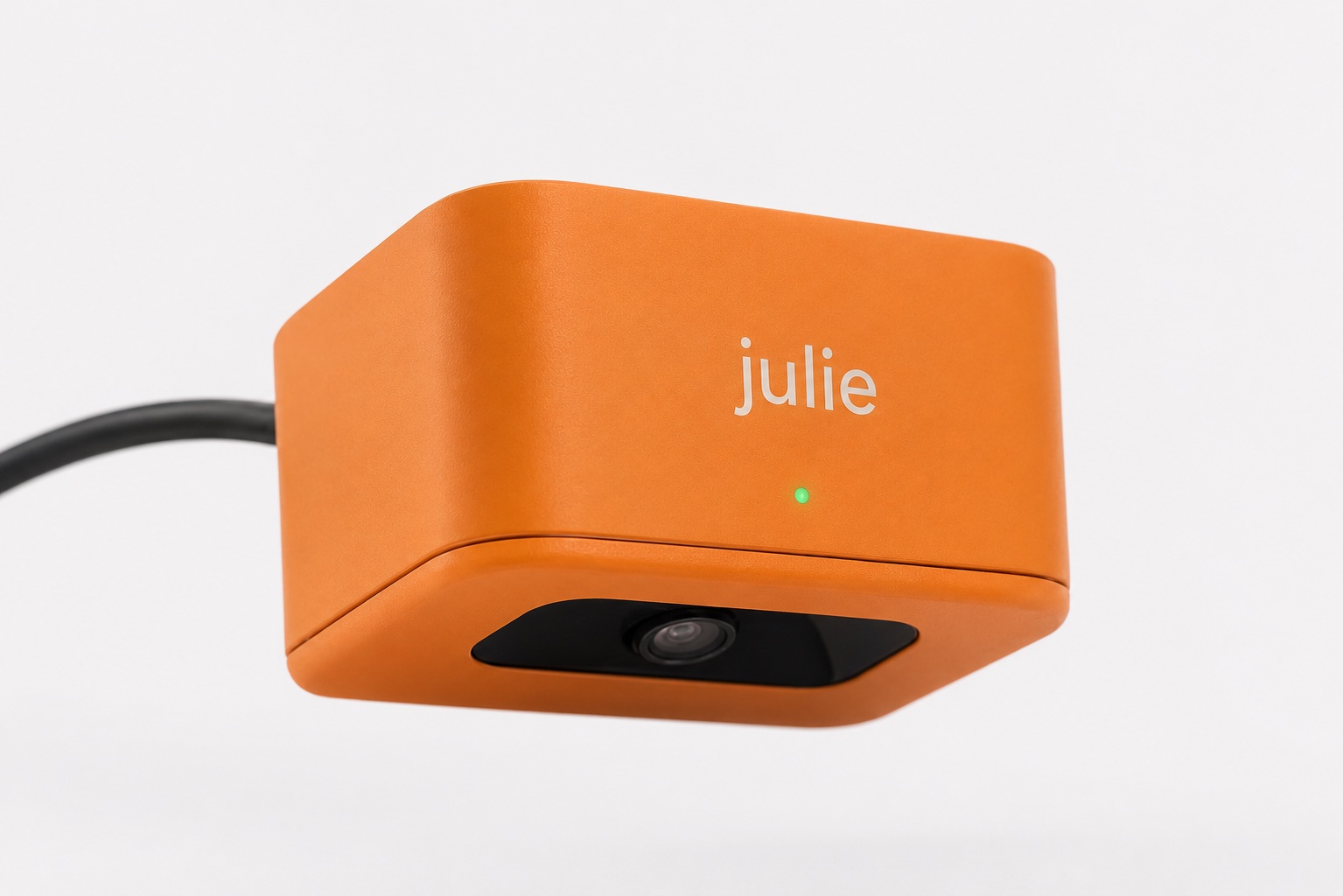 The Julie camera — a small orange unit with a downward-facing lens